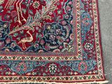 an image of a red and blue rug with a bird on it