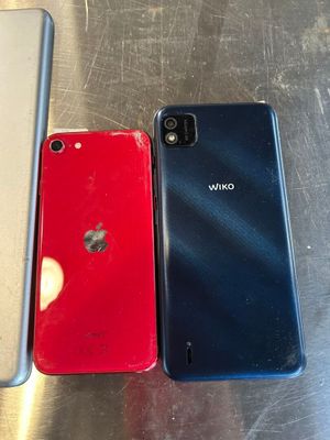 three different colored iphones sitting next to each other on a table