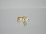 an image of a gold ring with a white stone on it