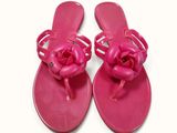 pair of pink flip flops with a knot on the toe