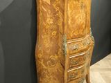 an old wooden cabinet sitting on top of a wooden floor next to a wall