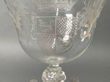 a clear glass bowl with a gold decoration on it