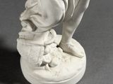 a white statue of a woman holding a baby
