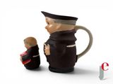 a figurine of a man holding a baby and a man wearing a hat