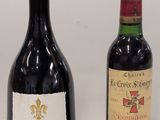two bottles of wine sitting next to each other on a table