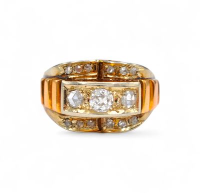 a close up of a gold and diamond ring on a white background