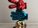 a statue of a hand with a glove on top of it