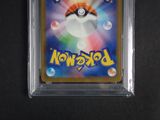 a close up of a pokemon trading card in a plastic case