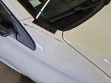 a white car that is parked in a garage