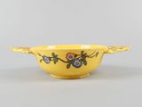 an image of a yellow bowl with flowers painted on it