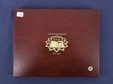 a wooden box with a gold medallion on top of it
