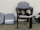 a chair that is sitting next to some trash cans