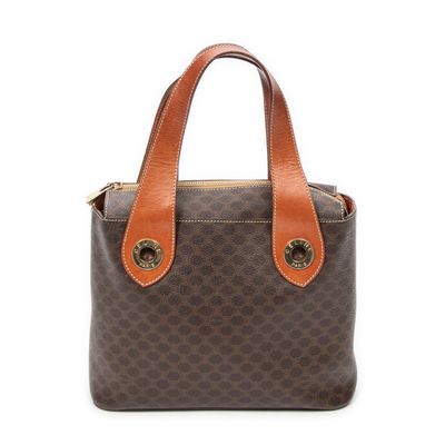 a brown and tan handbag with a brown handle