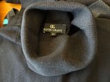 the back of a gray sweater with a black label on it
