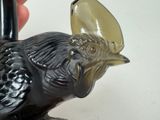 a black bird figurine sitting on a white table