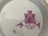a white plate with a purple design on it