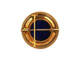 an image of a gold and blue broochle on a white background