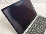 a laptop that is sitting on a white surface