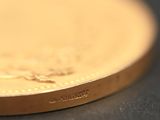 a close up of a gold coin on a table
