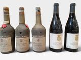 six bouteilles de vin sont alignées sur une surface blanche