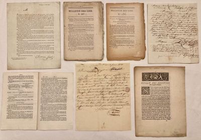 several old papers with writing on them sitting on a table