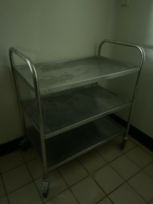 a metal cart in the corner of a room