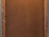 an old picture frame with a piece of brown paper taped around it