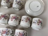 a lot of cups and saucers that are sitting on a table