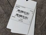 a close up of a tag on a sweater with a barcode on it