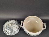 a small cup and saucer sitting next to each other