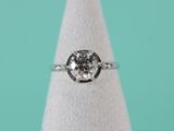 a close up of a diamond ring sitting on top of a white cone