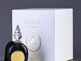 a close up of a bottle of perfume next to a box