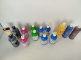 many different colors of ink on a white surface