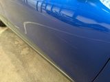 a close up of a car ' s door handle with a sticker on it