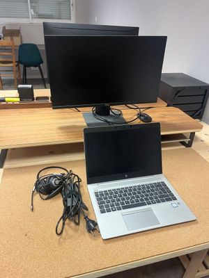 a desk with a laptop and a monitor on it