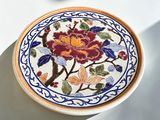 a plate with a floral design on it on a table