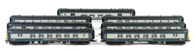 three black and white train cars sitting next to each other on a white surface