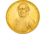 l'image d'une pièce d'or sur laquelle figure le portrait d'un homme