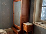 an image of a bedroom with a bed, dresser and window