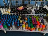 a rack with many different colored paint bottles on it
