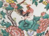 a large vase with a bird and flowers on it