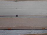 a mattress on a table in front of a garage door
