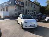 a small white car parked in front of a building