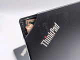 a black laptop with a picture of a man on the screen