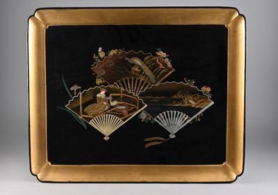 an image of a black and gold plate with a fan on it