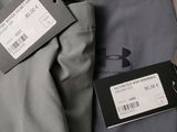 a close up of a gray jacket with a tag on it