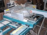 a picture of a sawing machine in a garage