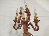 a candle holder that has five candles on top of it