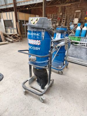 a blue machine that is on a cart in a warehouse