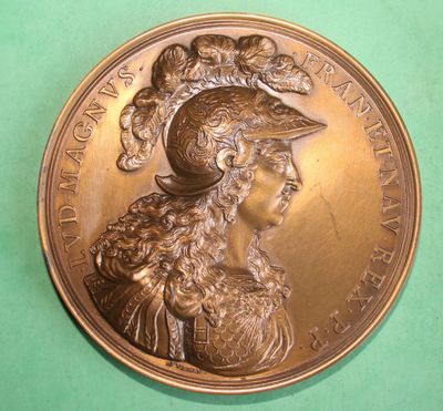 an image of a bronze medal with a woman wearing a hat
